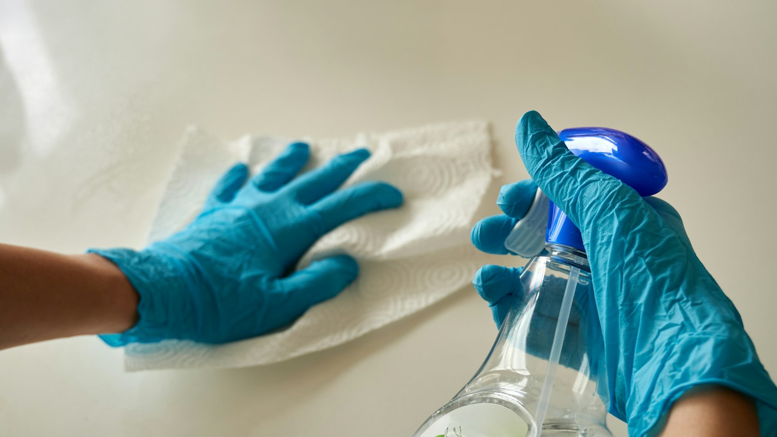 Technician treating a surface with an odor neutralizer